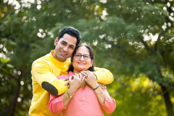 happy man embracing his mother with love at park
